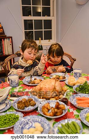 Kids eating in the house at Christmas View Large Photo Image Stock Photo - Kids eating in the house at Christmas. Fotosearch