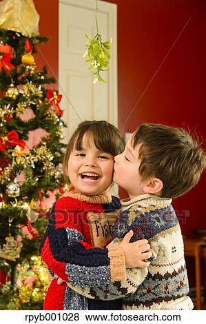 Kids kissing in the house at Christmas View Large Photo Image Stock Photo - Kids kissing in the house at Christmas. Fotosearch