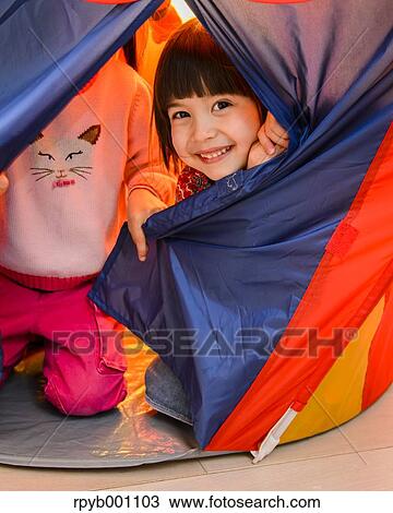 Stock Image - Kids playing in a children tent. Fotosearch