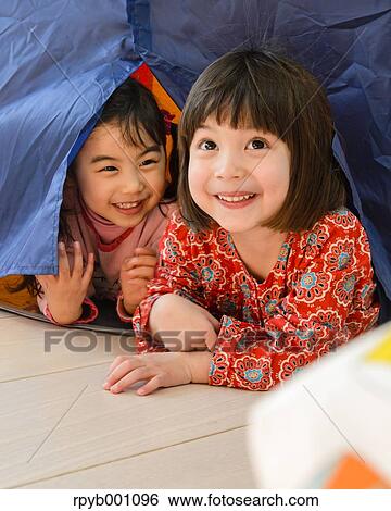 Stock Photograph - Kids playing in a children tent. Fotosearch