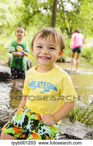 Kids playing in a city park View Large Photo Image Stock Image - Kids playing in a city park. Fotosearch