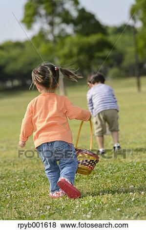 Kids playing in a city park View Large Photo Image Stock Photo - Kids playing in a city park. Fotosearch