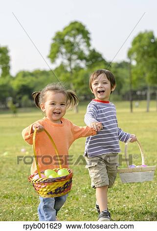 Kids playing in a city park View Large Photo Image Stock Photo - Kids playing in a city park. Fotosearch