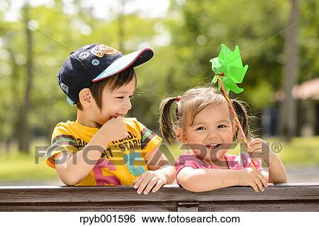 Kids playing in a city park View Large Photo Image Stock Photograph - Kids playing in a city park. Fotosearch