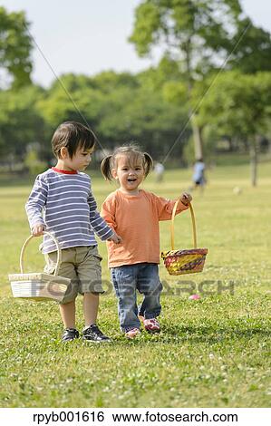 Kids playing in a city park View Large Photo Image Stock Photograph - Kids playing in a city park. Fotosearch