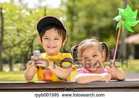 Kids playing in a city park View Large Photo Image Stock Photography - Kids playing in a city park. Fotosearch