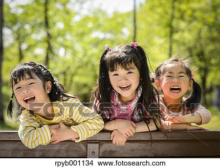 Kids playing in a park View Large Photo Image Picture - Kids playing in a park. Fotosearch