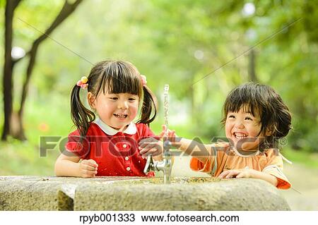 Kids playing in a park View Large Photo Image Stock Image - Kids playing in a park. Fotosearch