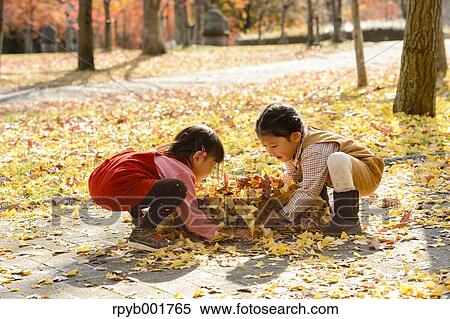Kids playing in a park View Large Photo Image Stock Photography - Kids playing in a park. Fotosearch
