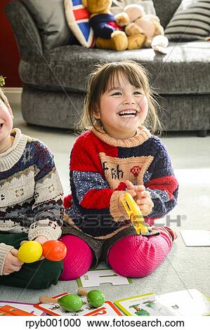 Stock Image - Kids playing in the house at Christmas. Fotosearch
