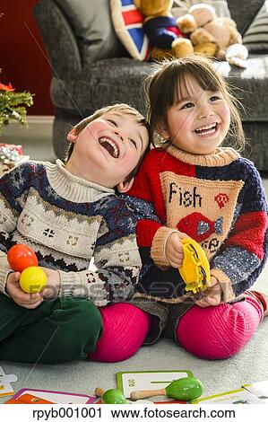 Kids playing in the house at Christmas View Large Photo Image Stock Image - Kids playing in the house at Christmas. Fotosearch