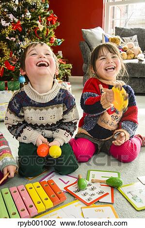 Kids playing in the house at Christmas View Large Photo Image Stock Image - Kids playing in the house at Christmas. Fotosearch