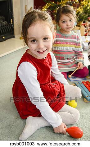 Kids playing in the house at Christmas View Large Photo Image Stock Image - Kids playing in the house at Christmas. Fotosearch