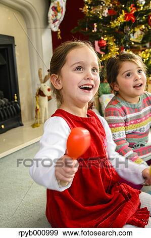 Stock Photo - Kids playing in the house at Christmas. Fotosearch