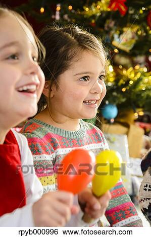 Kids playing in the house at Christmas View Large Photo Image Stock Photograph - Kids playing in the house at Christmas. Fotosearch