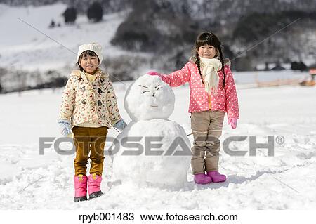 Kids playing in the snow View Large Photo Image Stock Image - Kids playing in the snow. Fotosearch