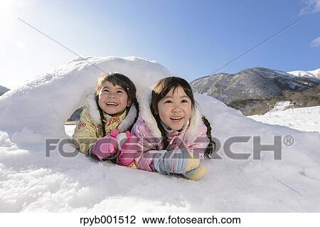Stock Image - Kids playing in the snow. Fotosearch
