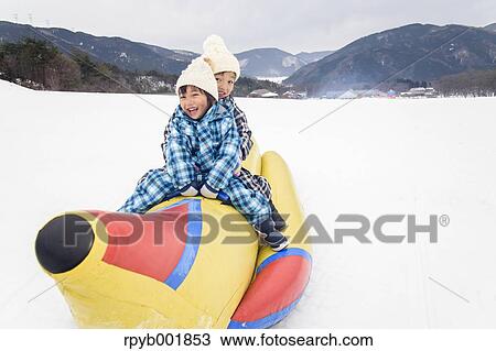 Kids playing in the snow View Large Photo Image Stock Image - Kids playing in the snow. Fotosearch