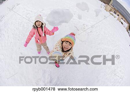 Kids playing in the snow View Large Photo Image Stock Photo - Kids playing in the snow. Fotosearch