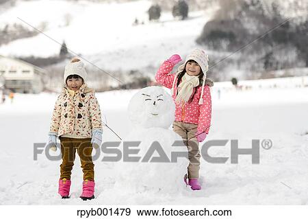 Kids playing in the snow View Large Photo Image Stock Photo - Kids playing in the snow. Fotosearch