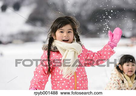 Kids playing in the snow View Large Photo Image Stock Photo - Kids playing in the snow. Fotosearch