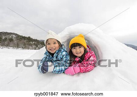 Kids playing in the snow View Large Photo Image Stock Photo - Kids playing in the snow. Fotosearch