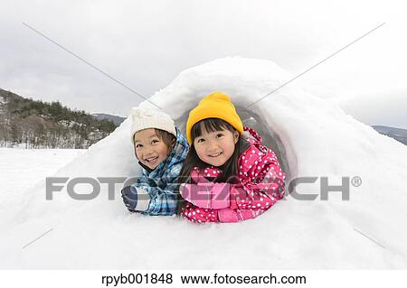 Kids playing in the snow View Large Photo Image Stock Photo - Kids playing in the snow. Fotosearch