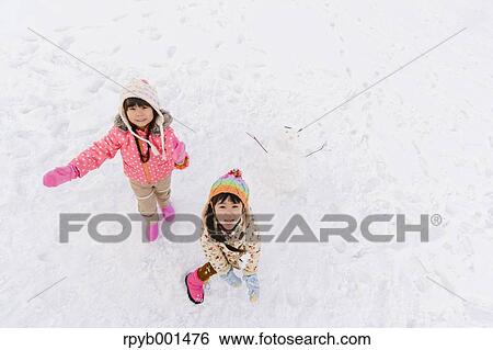 Kids playing in the snow View Large Photo Image Stock Photograph - Kids playing in the snow. Fotosearch