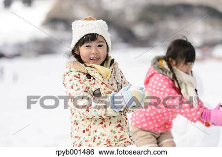 Kids playing in the snow View Large Photo Image Stock Photograph - Kids playing in the snow. Fotosearch