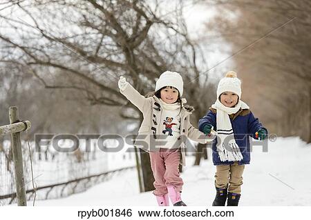 Kids playing in the snow View Large Photo Image Stock Photograph - Kids playing in the snow. Fotosearch