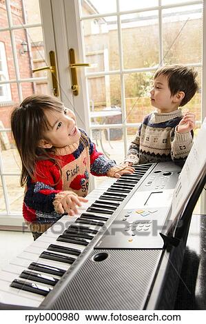 Kids playing piano View Large Photo Image Stock Image - Kids playing piano. Fotosearch