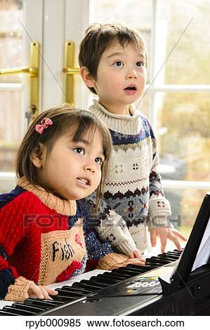 Kids playing piano View Large Photo Image Stock Photography - Kids playing piano. Fotosearch