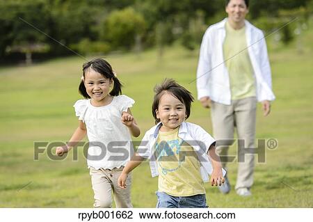 Stock Image - Kids with dad at the park. Fotosearch