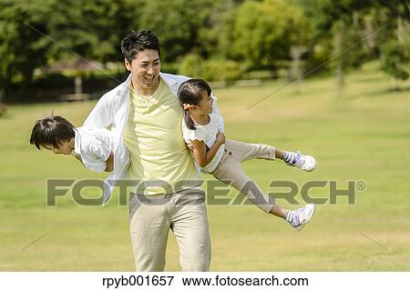 Kids with dad at the park View Large Photo Image Stock Photo - Kids with dad at the park. Fotosearch