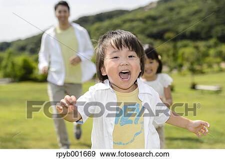 Stock Photo - Kids with dad at the park. Fotosearch