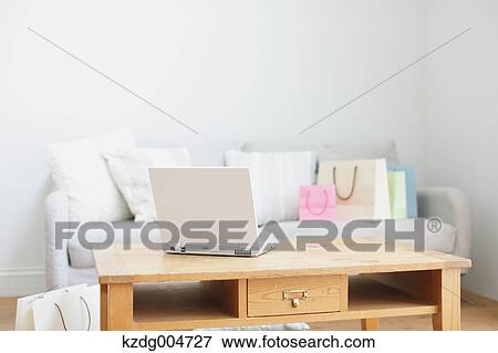 Laptop on table in the living room View Large Photo Image Stock Photo - Laptop on table in the living room. Fotosearch