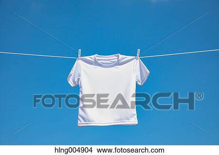 Laundry hanging against blue sky View Large Photo Image Picture - Laundry hanging against blue sky. Fotosearch