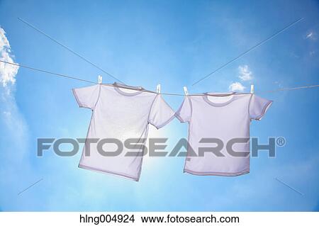 Laundry hanging against blue sky View Large Photo Image Picture - Laundry hanging against blue sky. Fotosearch