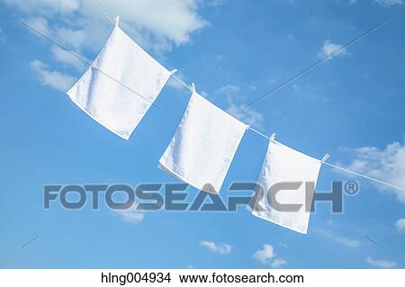 Laundry hanging against blue sky View Large Photo Image Picture - Laundry hanging against blue sky. Fotosearch