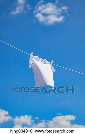 Laundry hanging against blue sky View Large Photo Image Stock Image - Laundry hanging against blue sky. Fotosearch