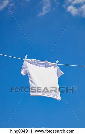 Stock Image - Laundry hanging against blue sky. Fotosearch