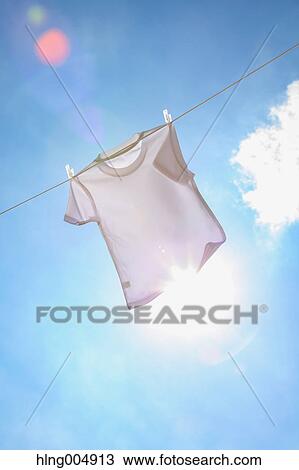 Laundry hanging against blue sky View Large Photo Image Stock Image - Laundry hanging against blue sky. Fotosearch