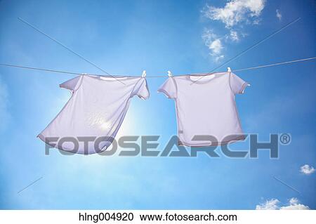 Laundry hanging against blue sky View Large Photo Image Stock Image - Laundry hanging against blue sky. Fotosearch