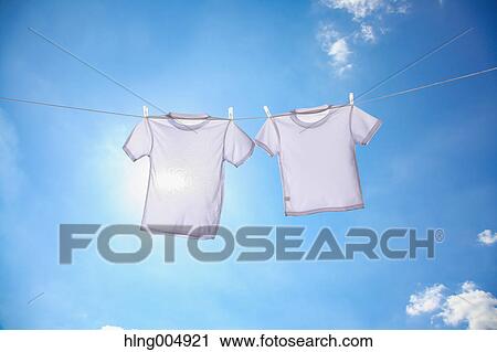 Laundry hanging against blue sky View Large Photo Image Stock Image - Laundry hanging against blue sky. Fotosearch