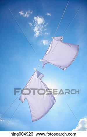 Laundry hanging against blue sky View Large Photo Image Stock Image - Laundry hanging against blue sky. Fotosearch