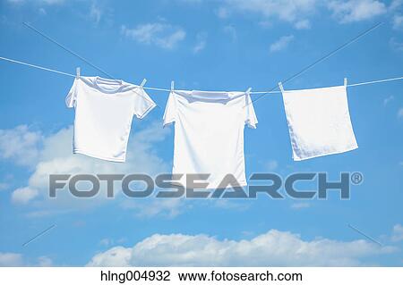 Laundry hanging against blue sky View Large Photo Image Stock Image - Laundry hanging against blue sky. Fotosearch