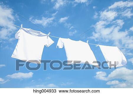 Laundry hanging against blue sky View Large Photo Image Stock Image - Laundry hanging against blue sky. Fotosearch