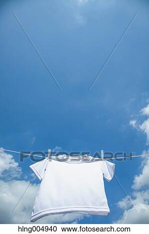 Stock Image - Laundry hanging against blue sky. Fotosearch