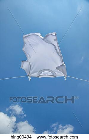 Laundry hanging against blue sky View Large Photo Image Stock Image - Laundry hanging against blue sky. Fotosearch