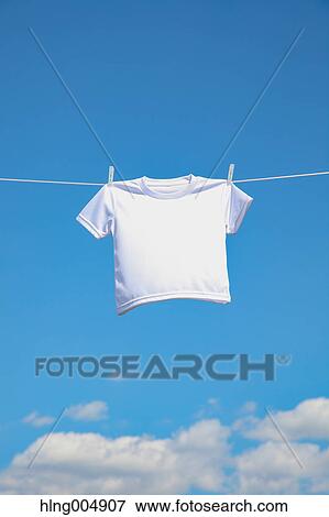 Stock Photo - Laundry hanging against blue sky. Fotosearch